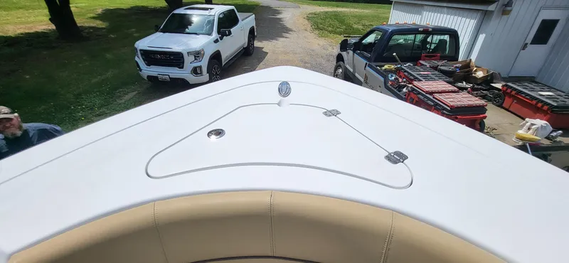 Slide: The Image of 2017 Sportsman Open 282 Center Console boat with trucks and tools in the background. - 11