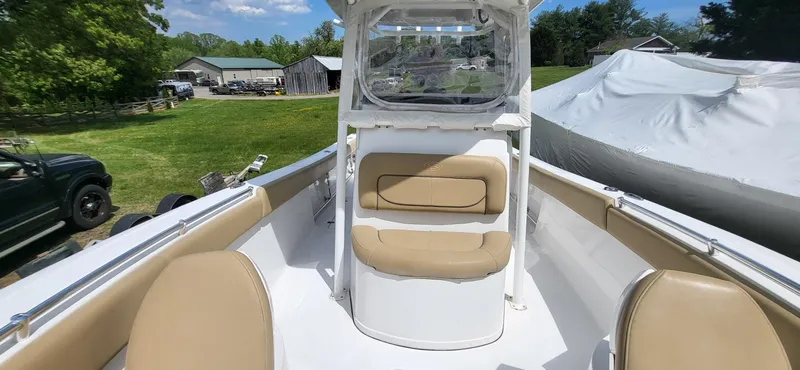 Slide: The Image of 2017 Sportsman Open 282 Center Console boat with tan seating, parked outdoors. - 12