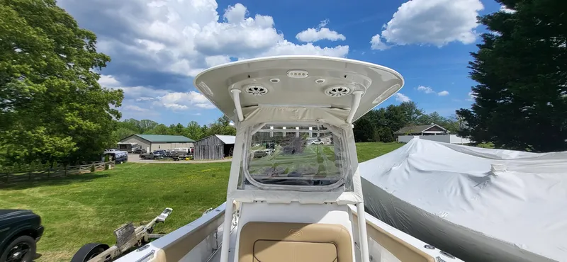 Slide: The Image of 2017 Sportsman Open 282 Center Console boat on grassy area under blue sky. - 13