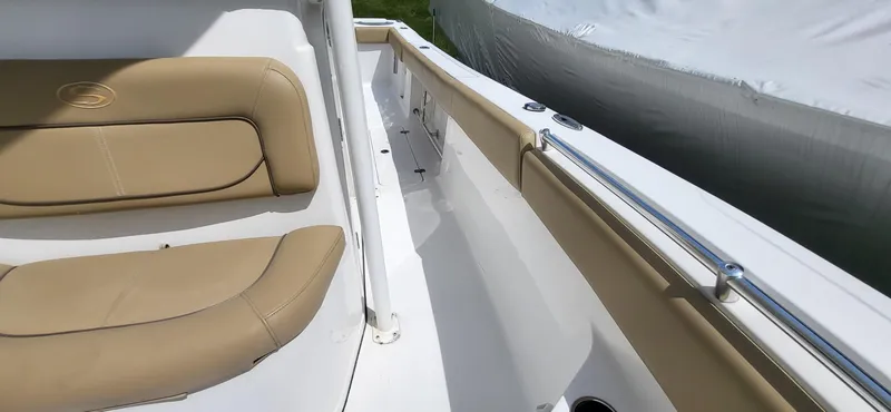 Slide: The Image of 2017 Sportsman Open 282 Center Console with tan seating and sleek white deck design. - 14
