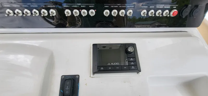 Slide: The Image of Control panel of a 2017 Sportsman Open 282 Center Console boat with JL Audio system. - 17