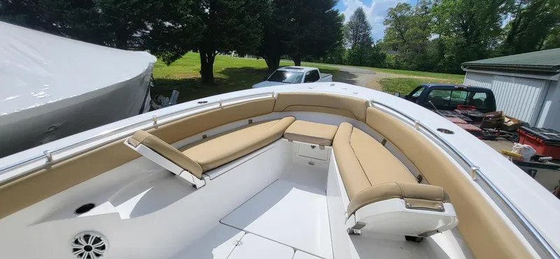 Slide: The Image of 2017 Sportsman Open 282 Center Console boat with tan seating, parked outdoors. - 4
