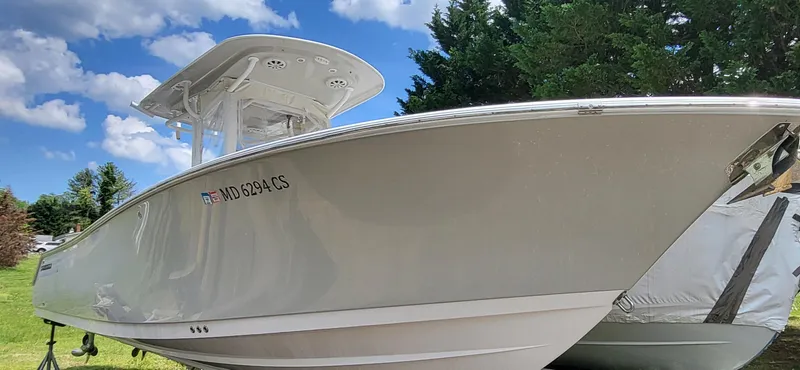Slide: The Image of 2017 Sportsman Open 282 Center Console boat on display outdoors. - 5