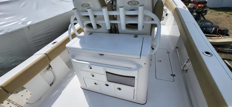 Slide: The Image of 2017 Sportsman Open 282 Center Console boat interior with storage and rod holders. - 8