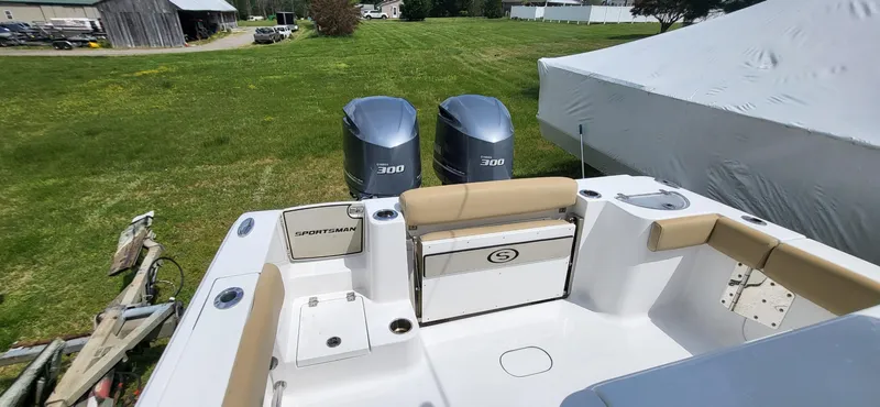 Slide: The Image of 2017 Sportsman Open 282 Center Console boat with twin 300 engines, parked on grass. - 9