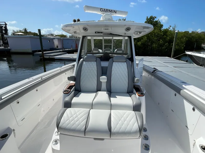 Slide: The Image of 2021 Everglades 395cc boat with luxurious seating and Garmin navigation system. - 12