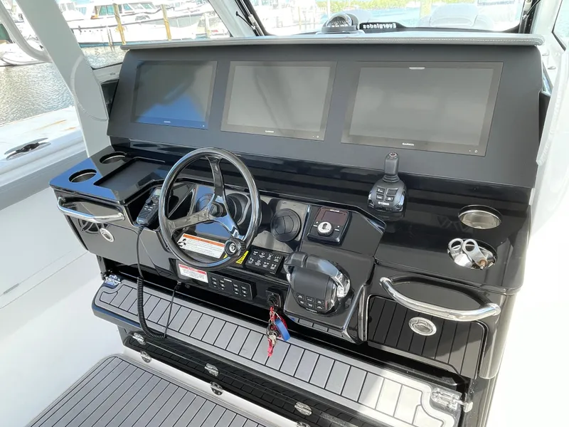 Slide: The Image of 2021 Everglades 395cc boat dashboard with steering wheel and electronic displays. - 19