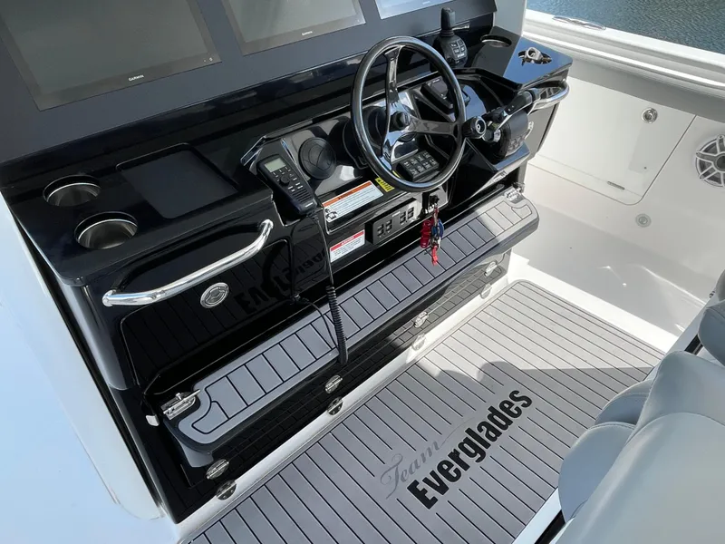 Slide: The Image of Control panel of 2021 Everglades 395cc boat with steering wheel and navigation screens. - 21