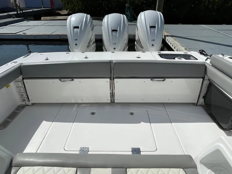 Slide: The Image of 2021 Everglades 395cc boat with triple outboard engines, spacious deck, and sleek design. - 24