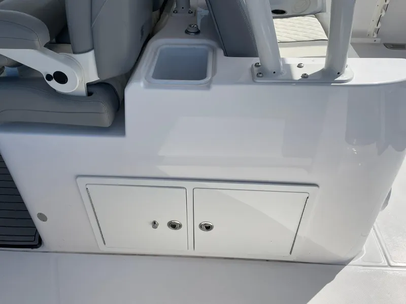 Slide: The Image of 2021 Everglades 395cc boat interior with storage compartments and seating. - 26