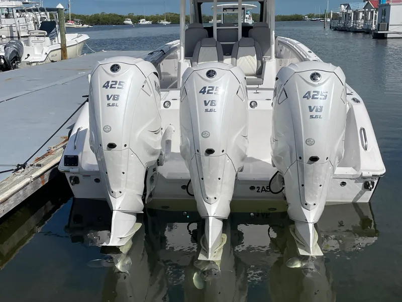 Slide: The Image of Triple Yamaha 425 V8 engines on a 2021 Everglades 395cc boat docked at a marina. - 4