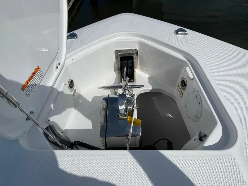 Slide: The Image of Anchor compartment of 2021 Everglades 395cc boat, featuring a neatly stored anchor and winch system. - 5
