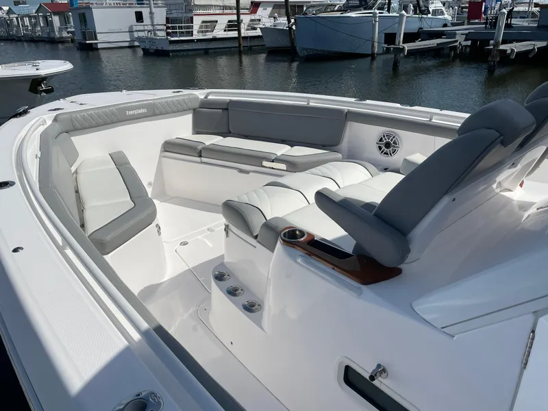 Slide: The Image of 2021 Everglades 395cc boat with spacious seating, docked at a marina. - 6