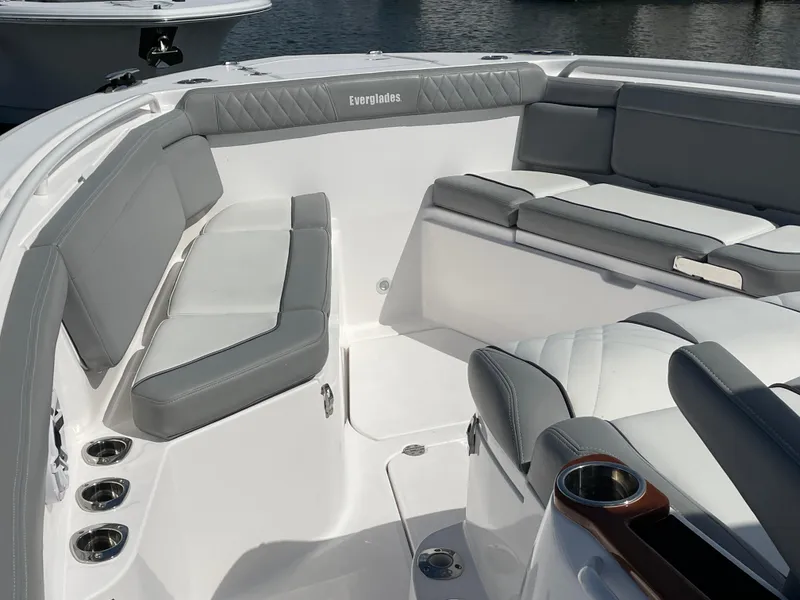 Slide: The Image of 2021 Everglades 395cc boat interior with gray seating and cup holders. - 8