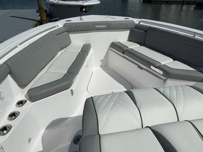 Slide: The Image of 2021 Everglades 395cc boat interior with gray seating, docked by the water. - 9