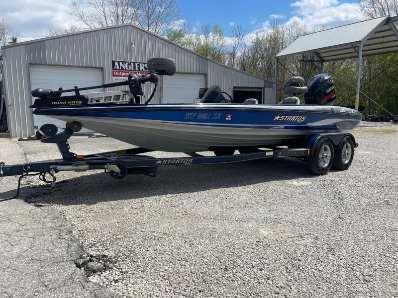Slide: The Image of 2005 Stratos 200 ProXL boat on trailer, parked outside a metal building. - 11