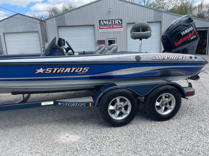 Slide: The Image of 2005 Stratos 200 ProXL boat with Yamaha engine, parked on gravel near Anglers shop. - 3