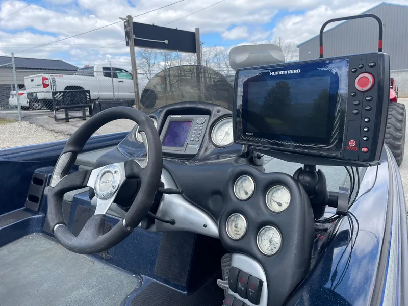 Slide: The Image of 2005 Stratos 200 ProXL boat dashboard with steering wheel and electronic displays. - 9