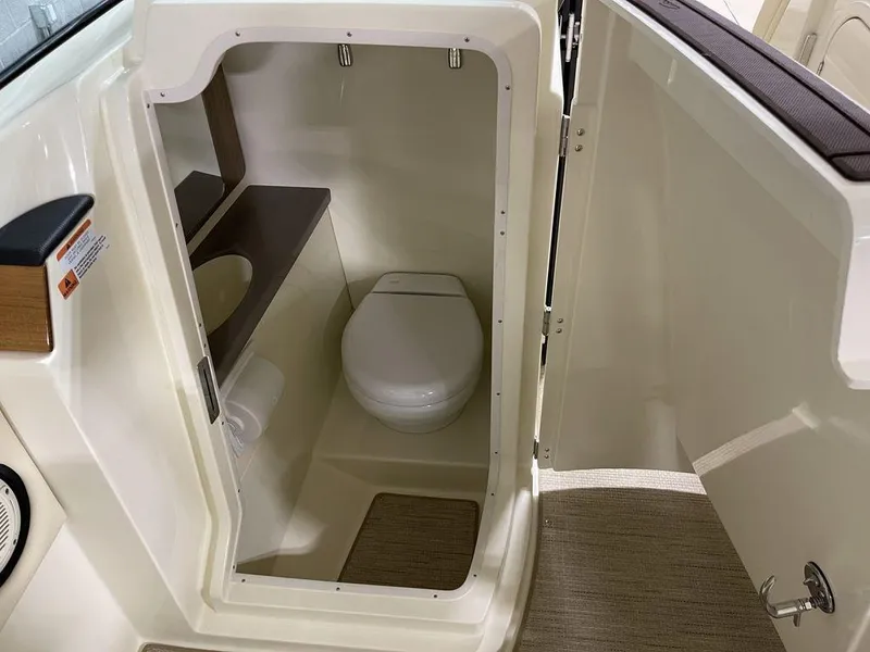 Slide: The Image of 2023 Chris-Craft 24 CALYPSO boat interior with compact bathroom and toilet. - 17