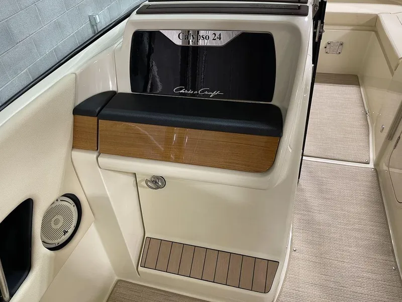 Slide: The Image of 2023 Chris-Craft 24 Calypso boat interior with elegant seating and wood accents. - 18