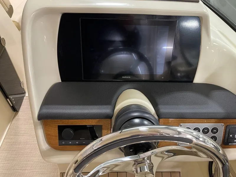 Slide: The Image of 2023 Chris-Craft 24 CALYPSO dashboard with steering wheel and touchscreen display. - 23