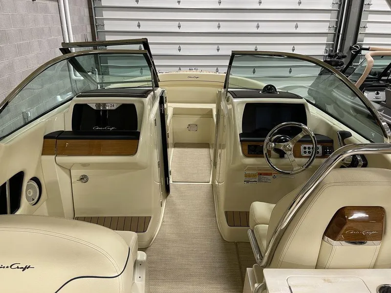 Slide: The Image of 2023 Chris-Craft 24 CALYPSO boat interior with beige seating and modern dashboard. - 25