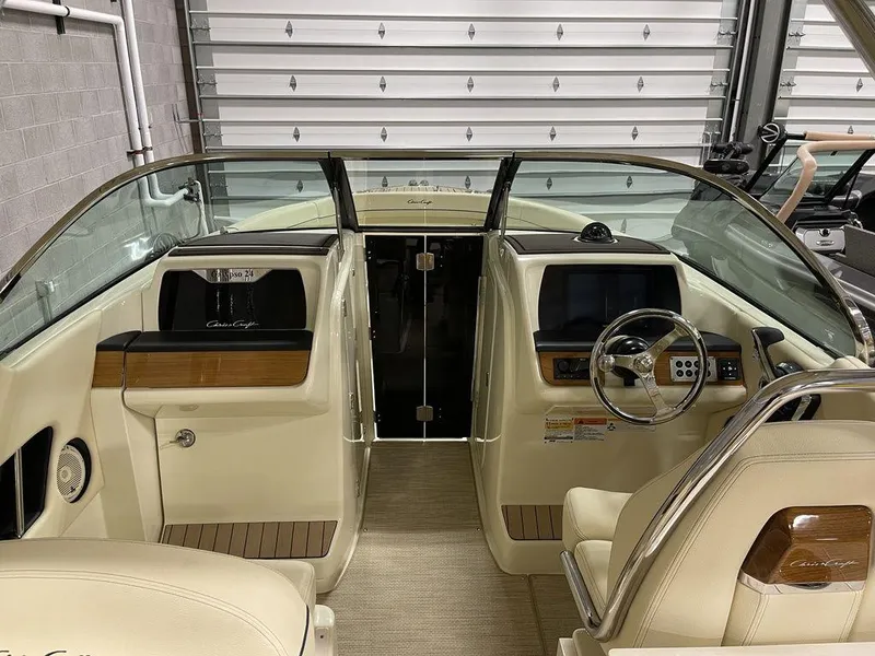 Slide: The Image of 2023 Chris-Craft 24 CALYPSO boat interior with beige seating and wooden accents. - 31