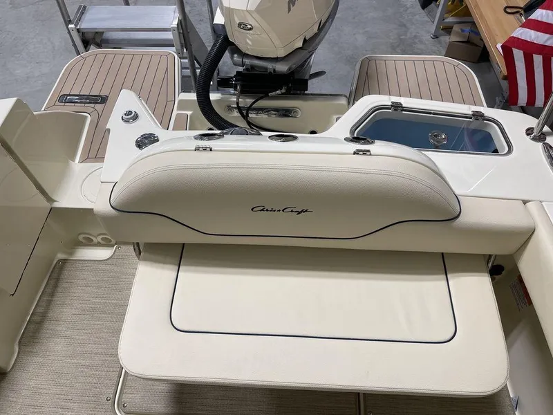 Slide: The Image of 2023 Chris-Craft 24 CALYPSO boat interior with seating and American flag. - 6