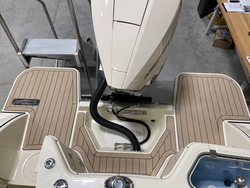 Slide: The Image of 2023 Chris-Craft 24 CALYPSO boat stern with outboard motor and teak decking. - 7