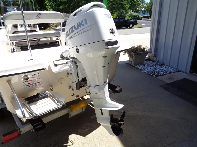 Slide: The Image of 2024 Carolina Skiff EL16JVX with Suzuki outboard motor, parked outdoors. - 14