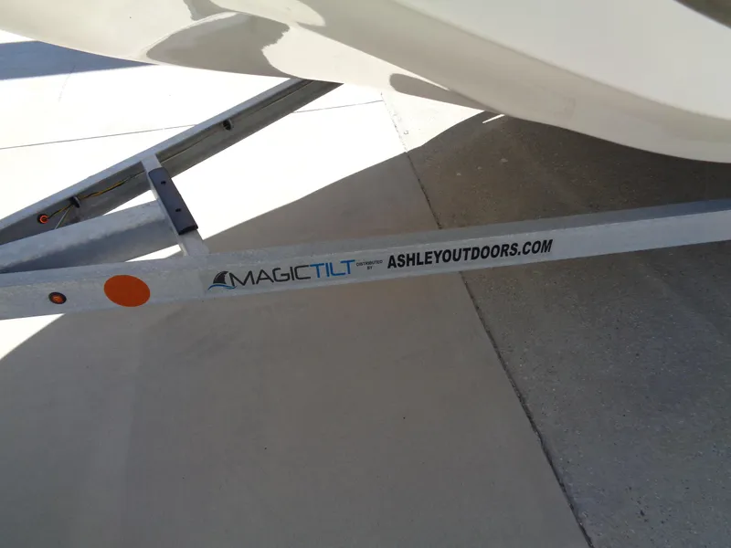 Slide: The Image of Trailer for 2024 Carolina Skiff EL16JVX, featuring Magic Tilt branding and AshleyOutdoors.com. - 17