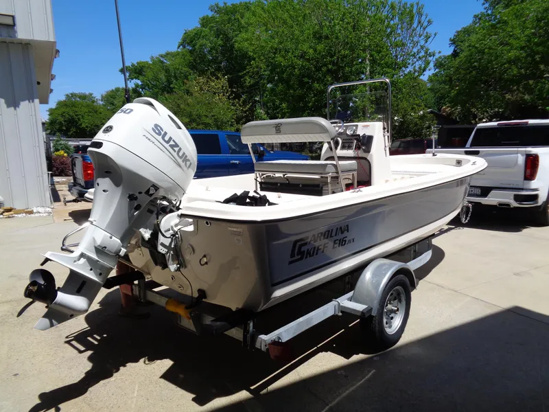Slide: The Image of 2024 Carolina Skiff EL16JVX boat on trailer with Suzuki outboard motor. - 4