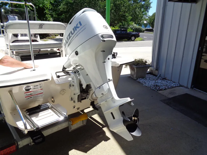 Slide: The Image of 2024 Carolina Skiff EL16JVX boat with Suzuki outboard motor, parked outdoors. - 5