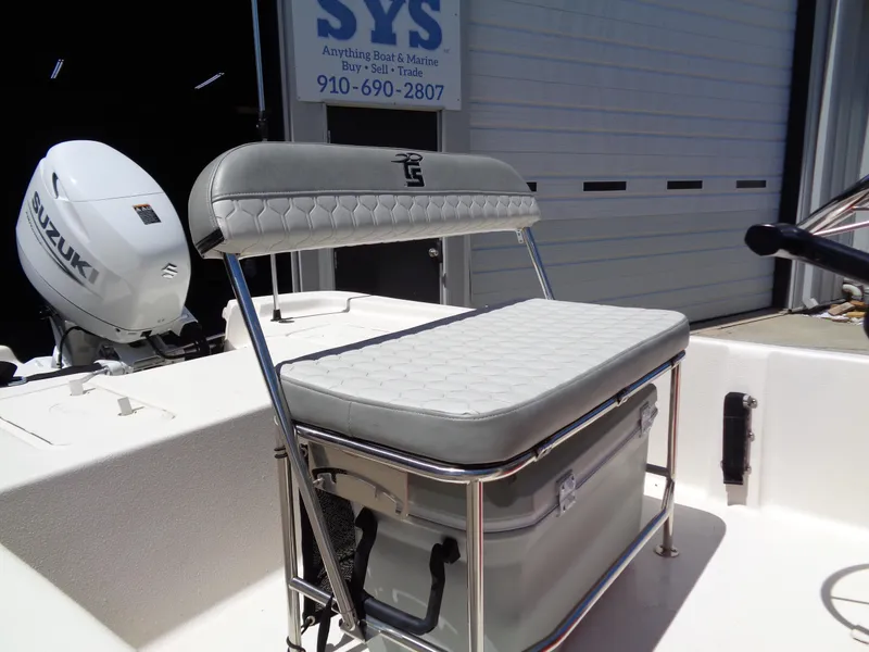 Slide: The Image of 2024 Carolina Skiff EL16JVX boat with Suzuki outboard motor and cushioned seating. - 8