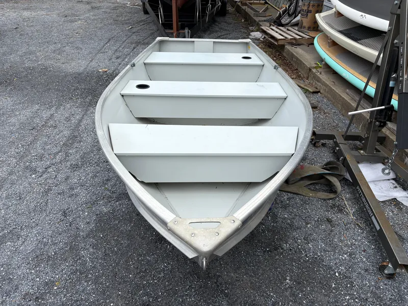 Slide: The Image of Duranautic 12 boat, 2021 model, on gravel surface, with three bench seats. - 4