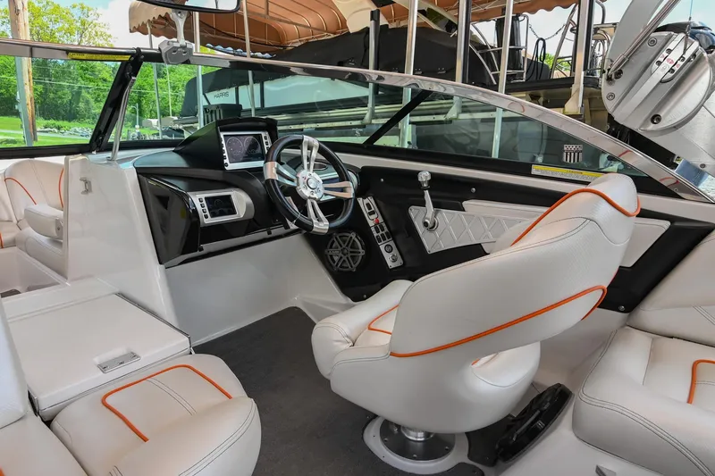 Slide: The Image of 2013 MasterCraft XStar boat interior with modern dashboard and white seating. - 15