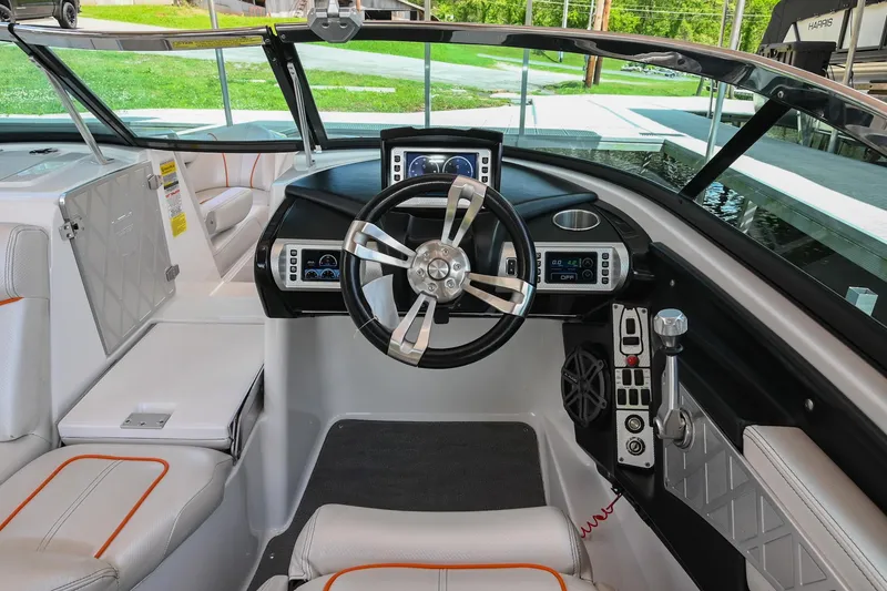Slide: The Image of 2013 MasterCraft XStar boat interior with modern dashboard and steering wheel. - 16