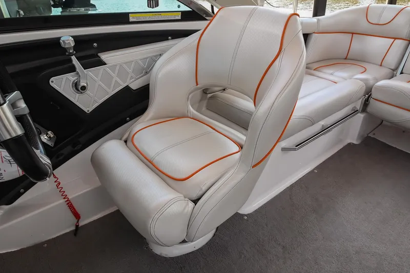 Slide: The Image of 2013 MasterCraft XStar interior with white and orange-trimmed seats. - 17