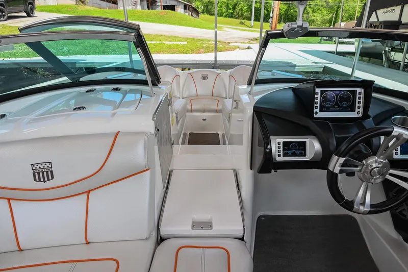 Slide: The Image of 2013 MasterCraft XStar boat interior with modern dashboard and seating. - 18