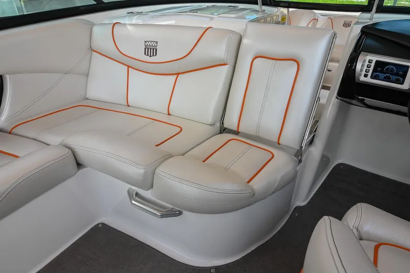 Slide: The Image of 2013 MasterCraft XStar interior with white and orange-trimmed seating, showcasing luxury and comfort. - 20