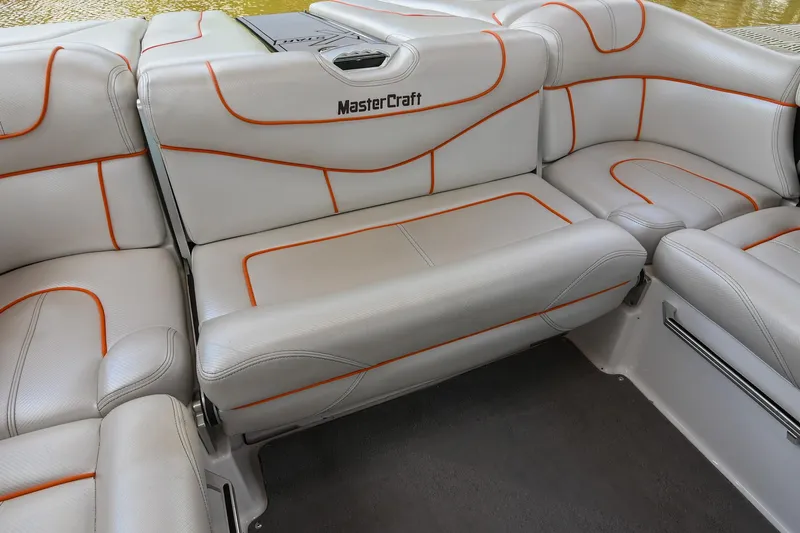 Slide: The Image of 2013 MasterCraft XStar boat interior with white and orange seating. - 21