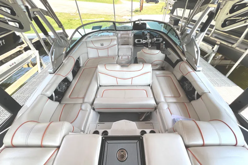 Slide: The Image of 2013 MasterCraft XStar boat interior with white leather seating and modern dashboard. - 22
