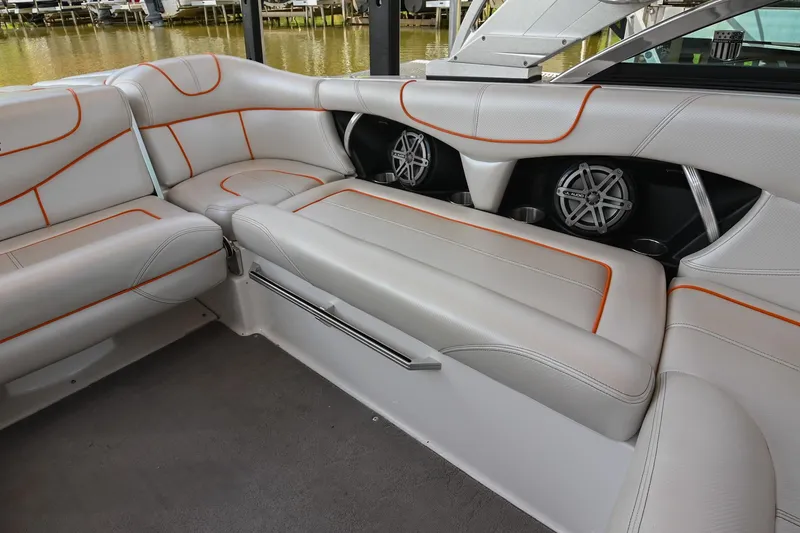 Slide: The Image of 2013 MasterCraft XStar interior with white leather seats and orange stitching. - 23