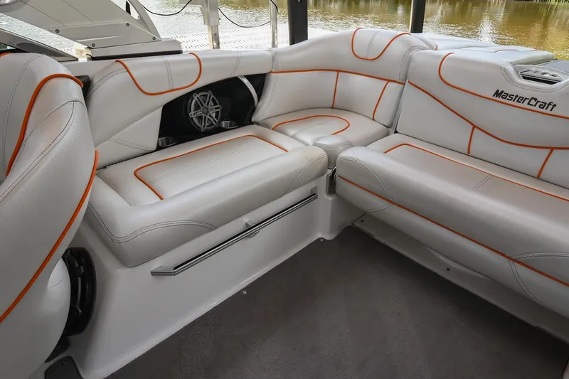 Slide: The Image of 2013 MasterCraft XStar interior with white leather seats and orange stitching. - 24