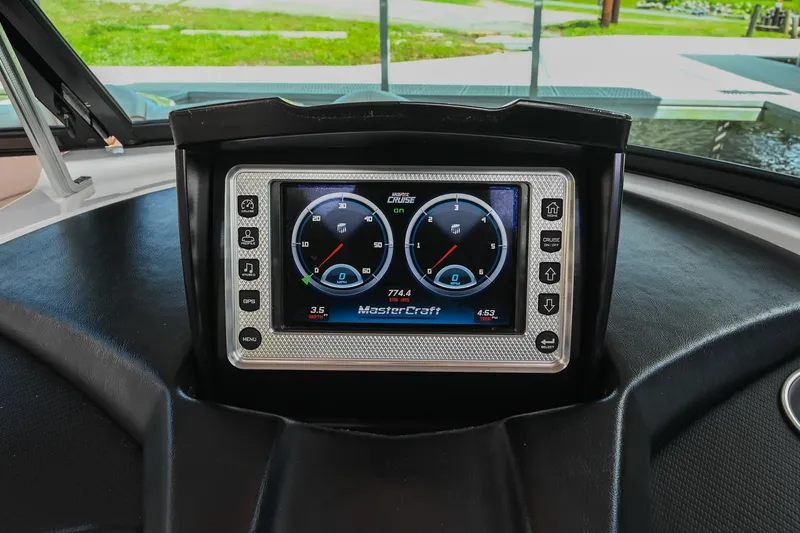 Slide: The Image of Dashboard of a 2013 MasterCraft XStar boat with digital display gauges. - 25