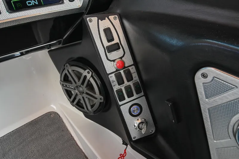 Slide: The Image of Control panel of a 2013 MasterCraft XStar boat with speaker and buttons. - 27