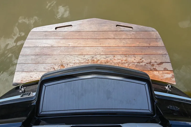 Slide: The Image of 2013 MasterCraft XStar swim platform with wooden finish on calm water. - 39