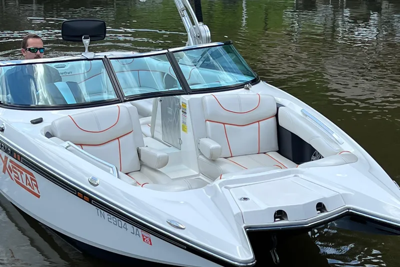 Slide: The Image of 2013 MasterCraft XStar boat on water, featuring sleek design and comfortable seating. - 4