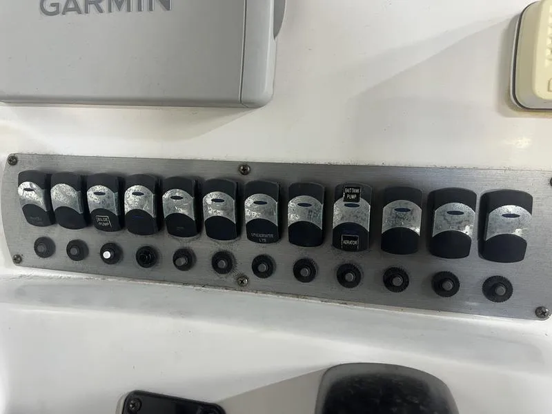 Slide: The Image of Control panel of a 2017 Hurricane 19 CC boat with labeled switches and Garmin device. - 10