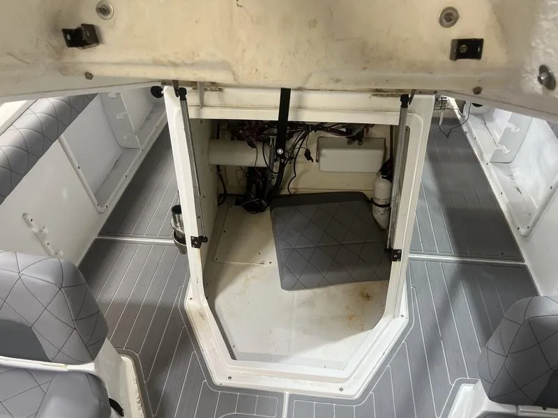 Slide: The Image of 2017 Hurricane 19 CC boat interior with open hatch and visible wiring. - 12